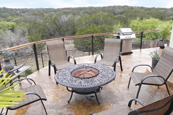 Stylish cable railing example on deck with fire pit.