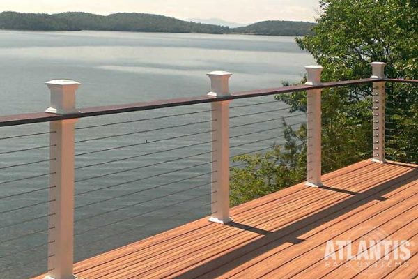 Top rail on cable railing on a lakefront deck.